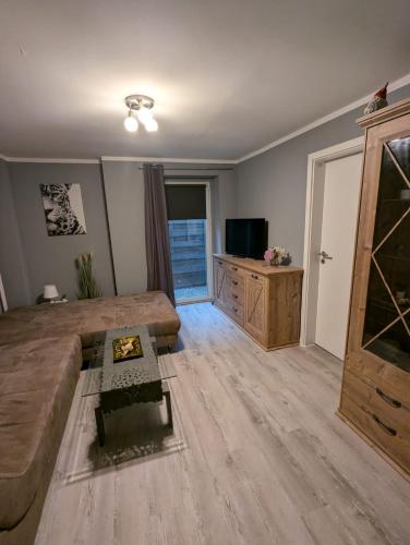 a living room with a couch and a television at Stadtnah an der Förde 7 HH M EG in Flensburg