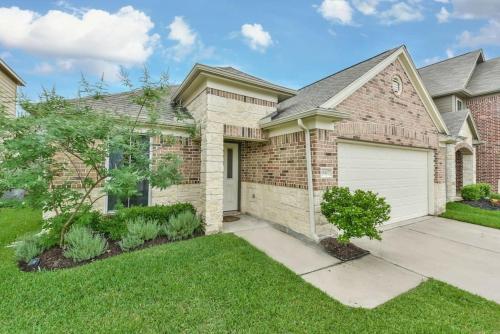 a brick house with a white garage at Early Green Home Sleeps 6 Yard King Suite in Houston