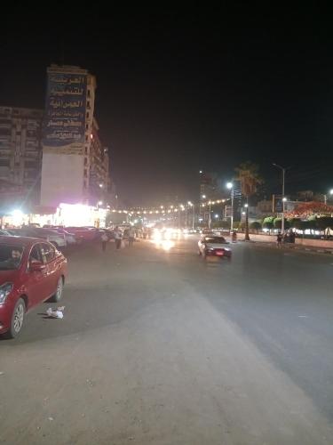 a parking lot at night with cars parked at شارع الجيش in Kafr Abū Dabbūs