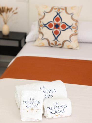 a hotel room with two towels on a bed at La Trinacria Rooms in Trapani