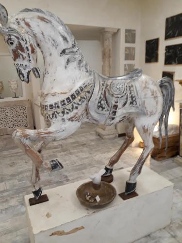 a statue of a horse on display in a museum at Hotel Minerva in Siena