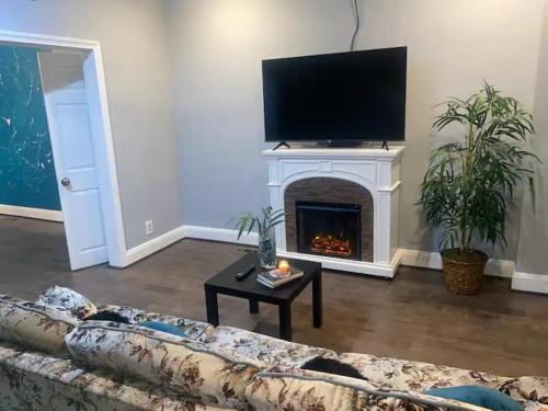 a living room with a couch and a fireplace at Home Away From Home in Baltimore