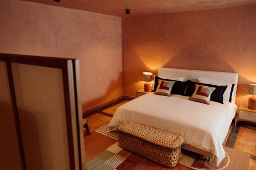 a bedroom with a large white bed with pillows at Maison Mexique Hotel Boutique San Miguel de Allende in San Miguel de Allende
