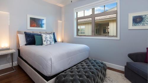 a small bedroom with a bed and a window at SEA GLASS Stunning 3BR KaMilo Home with Heated Pool and Best View in Waikoloa