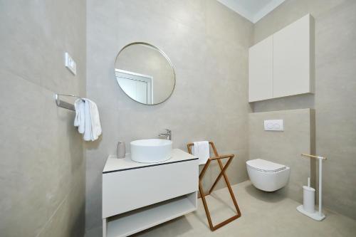a bathroom with a white sink and a mirror at Villa La Casa in Bibinje