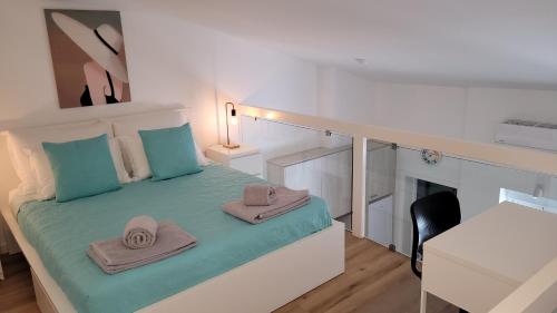 a bedroom with a bed with two towels on it at Guest House CR5 in Porto