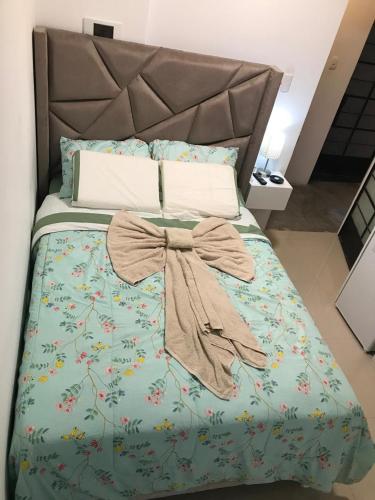 a bed with a blue comforter with a bow on it at Albano Habitación con cocina y baño in Mariscal Castilla