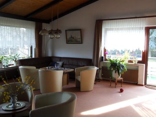a living room with a table and chairs at Hotel Del Sol in Bad Wildungen