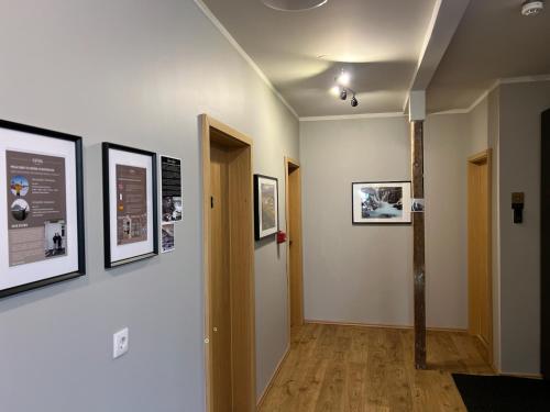 a hallway with pictures on the walls of a room at Bjork Guesthouse in Laugarvatn