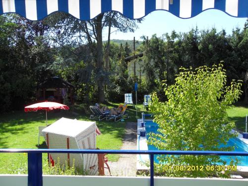 a view of a backyard with a swimming pool at Hotel Del Sol in Bad Wildungen