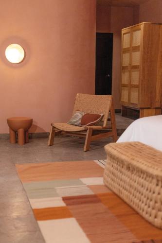 a room with a bed and a chair and a table at Maison Mexique Hotel Boutique San Miguel de Allende in San Miguel de Allende