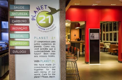 a sign in a restaurant with a menu at Ibis Porto Alegre Assis Brasil in Porto Alegre