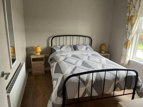 a bedroom with a bed with a gray and white comforter at Keeranglen Holiday Rental in Pomeroy