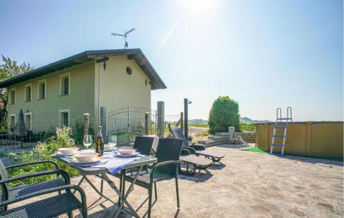 a patio with a table and chairs and a house at Gorgeous Home In Murazzano With Wifi in Murazzano