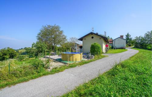 a road next to a house and a field at Gorgeous Home In Murazzano With Wifi in Murazzano