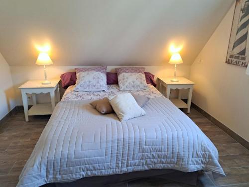 a bedroom with two beds with pillows and two lamps at Cottage in Plouneour-Trez with Sea View in Plounéour-Trez