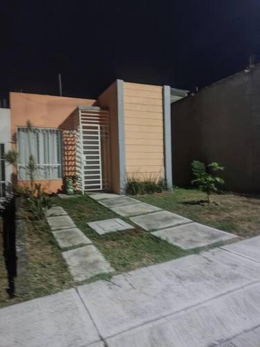 a house with a sidewalk next to a fence at Casa Orquídea in Morelia