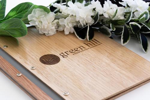 a wooden cutting board with white flowers on it at Hillside House at Bald Knob in Bald Knob