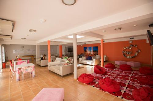 a large living room with red pillows on the floor at HI Portimão - Pousada de Juventude in Portimão