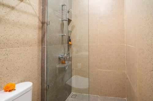 a shower with a glass door in a bathroom at Alyxia 1 Bedroom Apartment in Central Seminyak in Seminyak