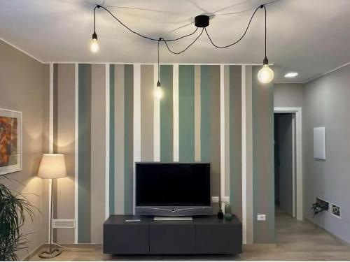 a living room with a tv on a striped wall at Apartment in Esanatoglia near Apennines Trails in Esanatoglia