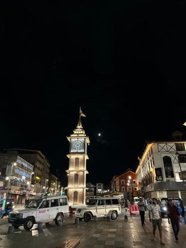 a clock tower in a city at night at Movie land group of house boats in Srinagar