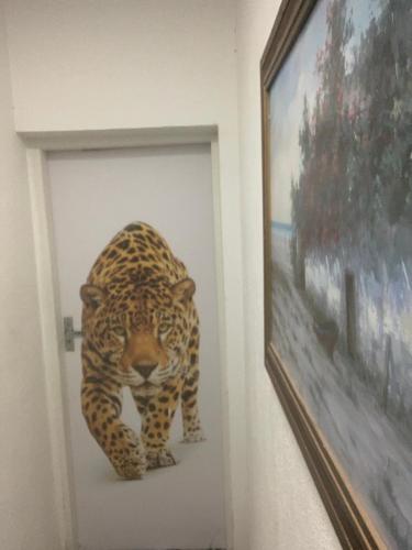 a painting of a jaguar on a wall at Hotel Pantanal in Cuiabá