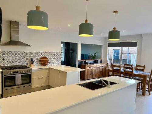 a kitchen with a kitchen island with a counter top at Caroline in Orange