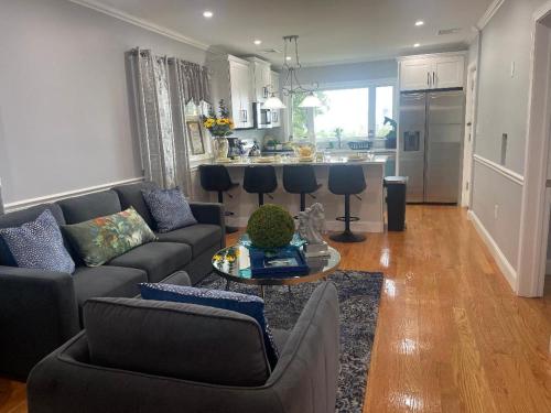 a living room with a couch and a table at Spectacular Boston City View in Boston
