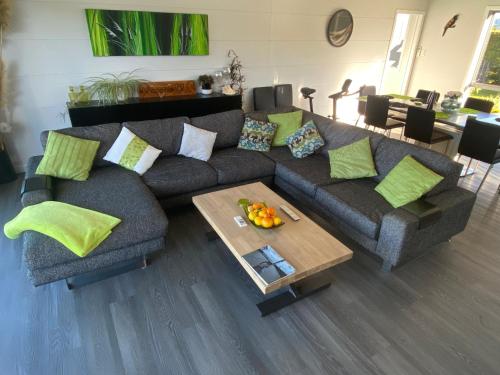 a living room with a couch and a coffee table at Moko Hiwi Escape - Kotare Suite in Ruakaka
