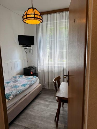 a bedroom with a bed and a table and a lamp at Landhotel Waldschänke in Berlin