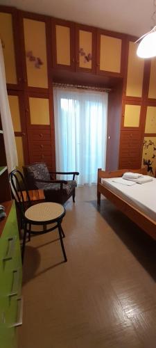 a bedroom with a bed and a couch and a table at Karya House in Kariá