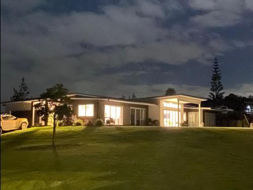 a house at night with the lights on at Moko Hiwi Escape Ruakākā- Huia Suite in Ruakaka