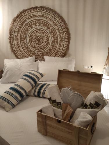 a wooden crate on a bed with a box of towels at Pasiphae Luxury House in Ierapetra