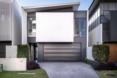 a large white sign on the side of a house at Luxury Lakeside Living at Birtinya in Kawana Waters