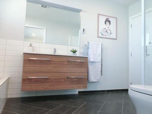 a bathroom with a sink and a toilet at Stunning Seaviews in Wellington
