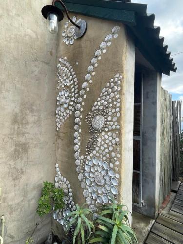 a wall with a design of shells on it at Love Nest in Pringle Bay