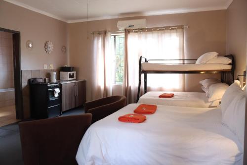 two beds in a room with two bunk beds at The Ultimate Lodge in Louis Trichardt