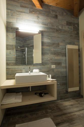 a bathroom with a sink and a mirror at La Burla in Borgosesia