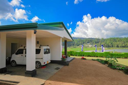 a white van parked in front of a building at Lulu's Bungalow in Nuwara Eliya