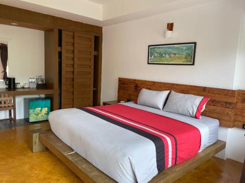 a bedroom with a large bed with a wooden headboard at See Through Resort Haad Yao in Haad Yao