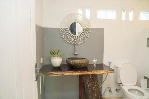a bathroom with a sink and a mirror on a table at Aranka Tempasan in Sangyang