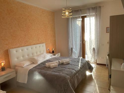 a bedroom with a bed with two towels on it at Hotel Panoramica in Bardolino