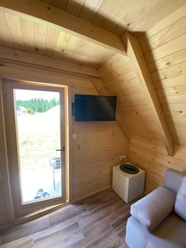 a room with a large window in a log cabin at Podgora 1 in Žabljak