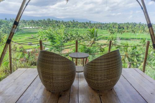 a table and chairs on a wooden deck with a view at Aranka Tempasan in Sangyang