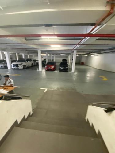 a parking garage with two cars parked in it at LoFF Suite River View 2 Bedroom at Kuching Riverine Resort in Kuching
