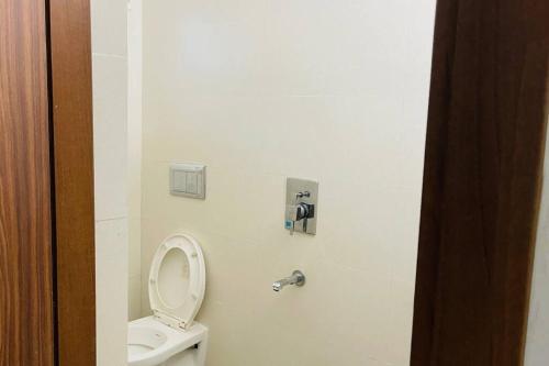 a bathroom with a white toilet and a sink at Rajamandiram 3BHK AC,Near Sree Padmanabhaswamy Temple, Trivandrum Central in Trivandrum