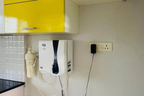a hair dryer on a wall in a kitchen at Rajamandiram 3BHK AC,Near Sree Padmanabhaswamy Temple, Trivandrum Central in Trivandrum