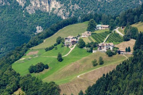 an aerial view of a house on a hill at Berggasthof Locanda Alpina Dorfner in Montagna