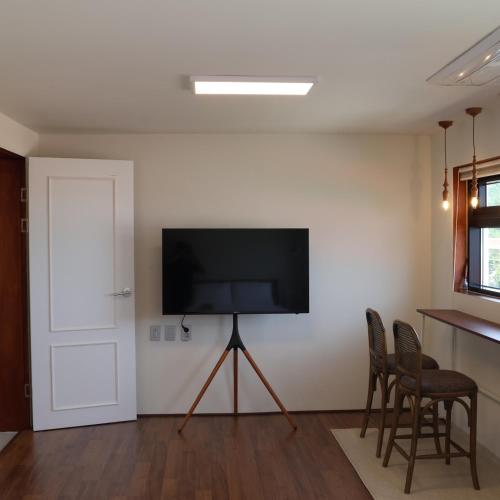 a living room with a flat screen tv on a wall at Yeongjingil 51 in Gangneung